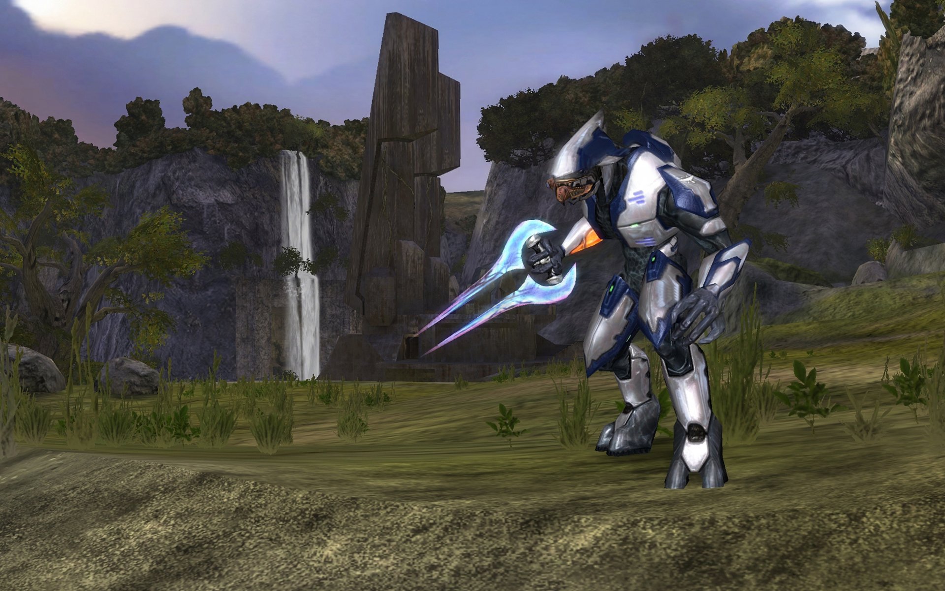 HD PC desktop wallpaper featuring a futuristic armored soldier from the Halo video game series in a lush, rocky landscape with a waterfall in the background.