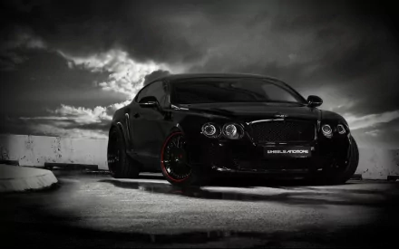 A sleek black Bentley parked against a dramatic, cloudy backdrop, showcasing its luxurious design and bold presence, making for an impressive HD wallpaper.