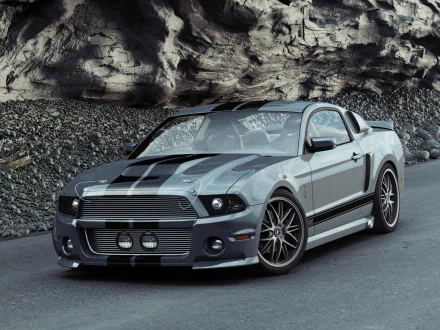 A sleek Ford vehicle, featuring a striking gray exterior with bold black stripes, is displayed against a rugged rocky backdrop, making for an impressive HD desktop wallpaper.
