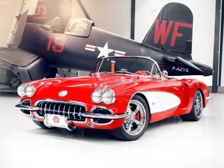 A vibrant red Chevrolet convertible showcased in front of a vintage military aircraft, captured in high definition as a PC desktop wallpaper and background.