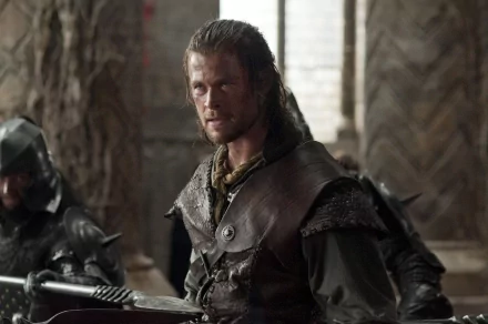 Chris Hemsworth as the Huntsman in a scene from the movie Snow White and the Huntsman, featured in an HD PC desktop wallpaper and background.