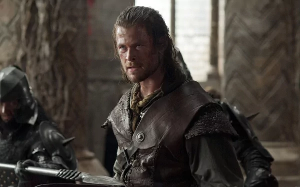 Chris Hemsworth as the Huntsman in a scene from the movie Snow White and the Huntsman, featured in an HD PC desktop wallpaper and background.