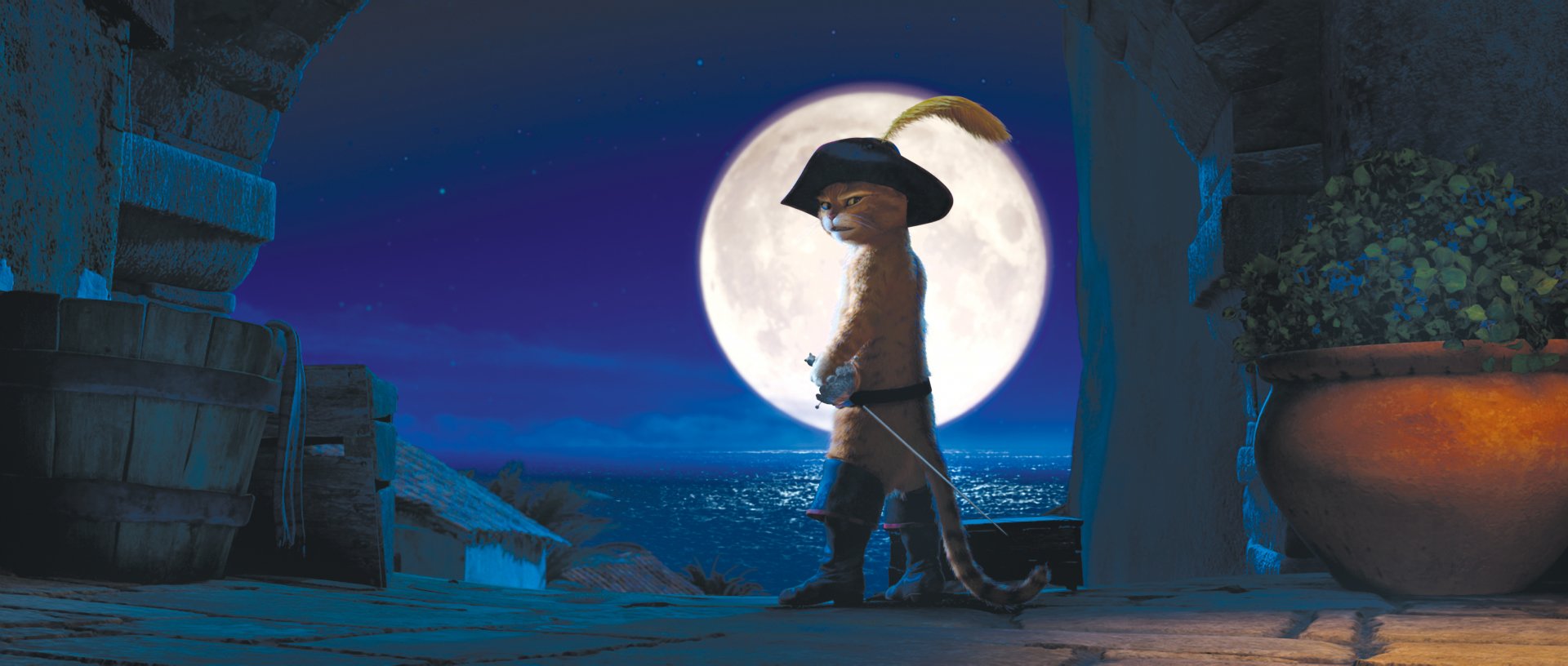 HD PC desktop wallpaper featuring Puss in Boots from the movie, standing confidently with a sword against a full moon over a nighttime ocean backdrop.