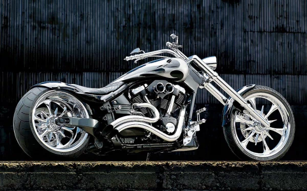 A sleek motorcycle is showcased against a dark textured background, highlighting its chrome details and modern design. This HD desktop wallpaper captures the essence of powerful vehicles.