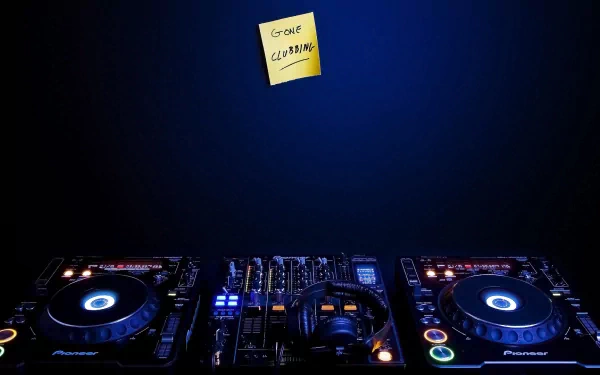 A vibrant HD desktop wallpaper featuring DJ equipment illuminated in blue light, with a sticky note reading Gone Cleaning adding a touch of humor to the music-themed scene.
