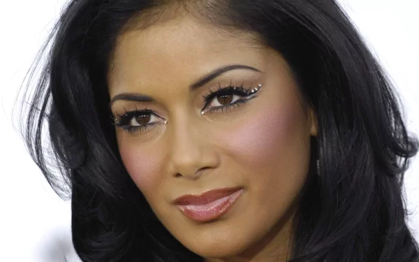 HD desktop wallpaper featuring a close-up portrait of Nicole Scherzinger with elegant makeup, highlighting her connection to music.
