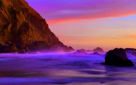 Scenic HD wallpaper of a coastline featuring a rugged cliff, a serene shoreline, and the purple hue of the ocean under a vibrant sunset sky.