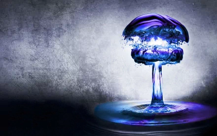 Artistic HD PC desktop wallpaper featuring a striking water splash shaped like a mushroom cloud, illuminated with blue and purple tones against a textured gray background.
