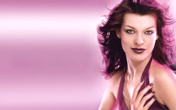 HD PC desktop wallpaper featuring celebrity Milla Jovovich with flowing dark hair against a pink gradient background.