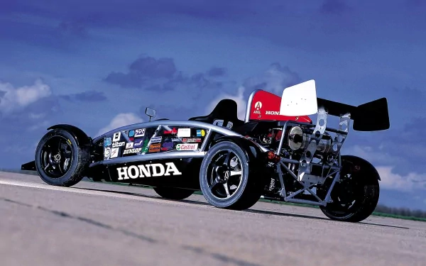 HD PC desktop wallpaper: Ariel Atom open-wheel vehicle on a sunlit road, black Honda-branded exposed-frame sports car under a blue sky.