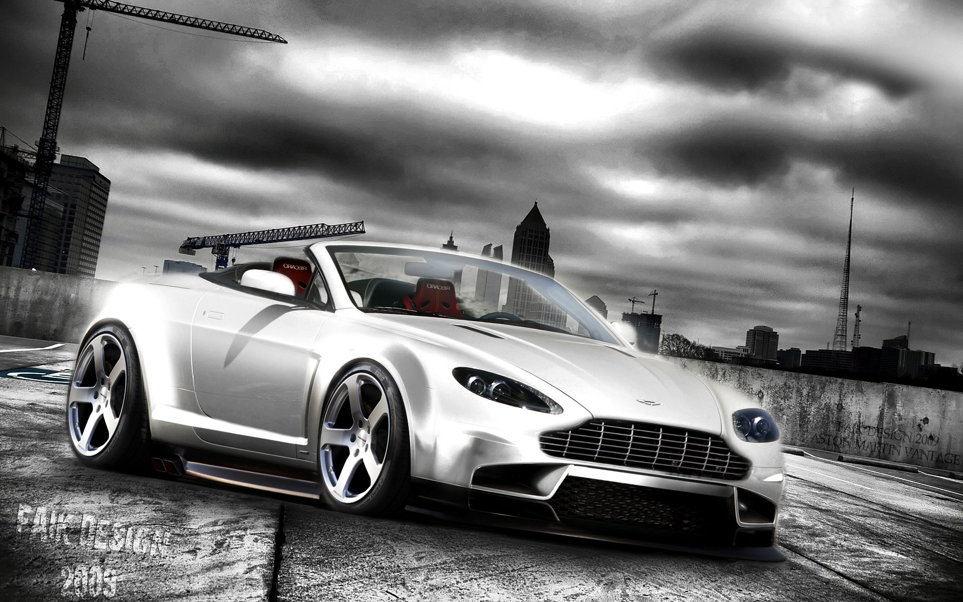 HD PC desktop wallpaper of a white Aston Martin V8 Vantage sports car with red interior and chrome wheels parked on an urban rooftop under dramatic cloudy skies, city skyline and cranes behind.