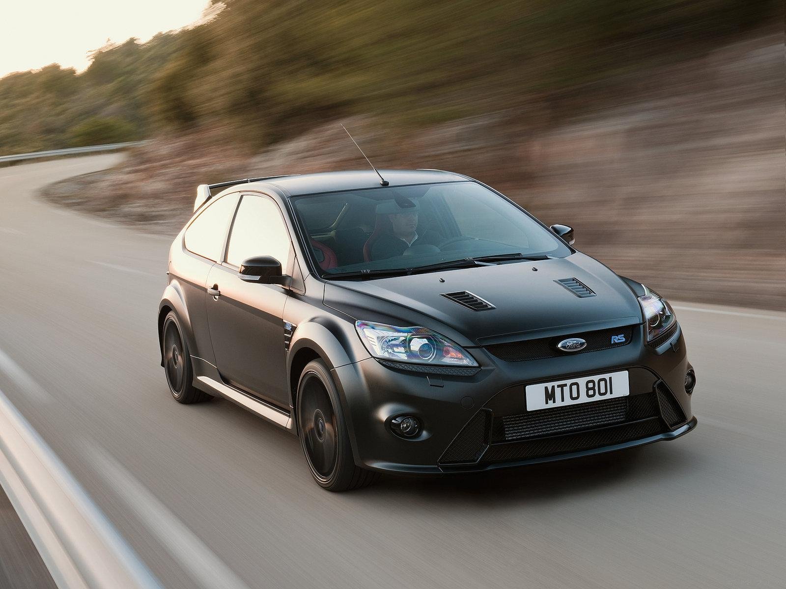 HD PC desktop wallpaper featuring a sleek black Ford Focus RS driving on a winding road with blurred background, highlighting the vehicle's dynamic design and performance.