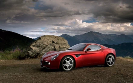 Red Alfa Romeo 8C Competizione sports vehicle on a mountain overlook under dramatic clouds — HD desktop wallpaper/background.