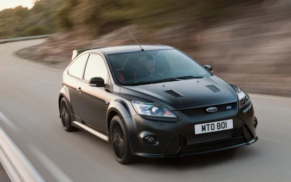 HD PC desktop wallpaper featuring a sleek black Ford Focus RS driving on a winding road with blurred background, highlighting the vehicle's dynamic design and performance.