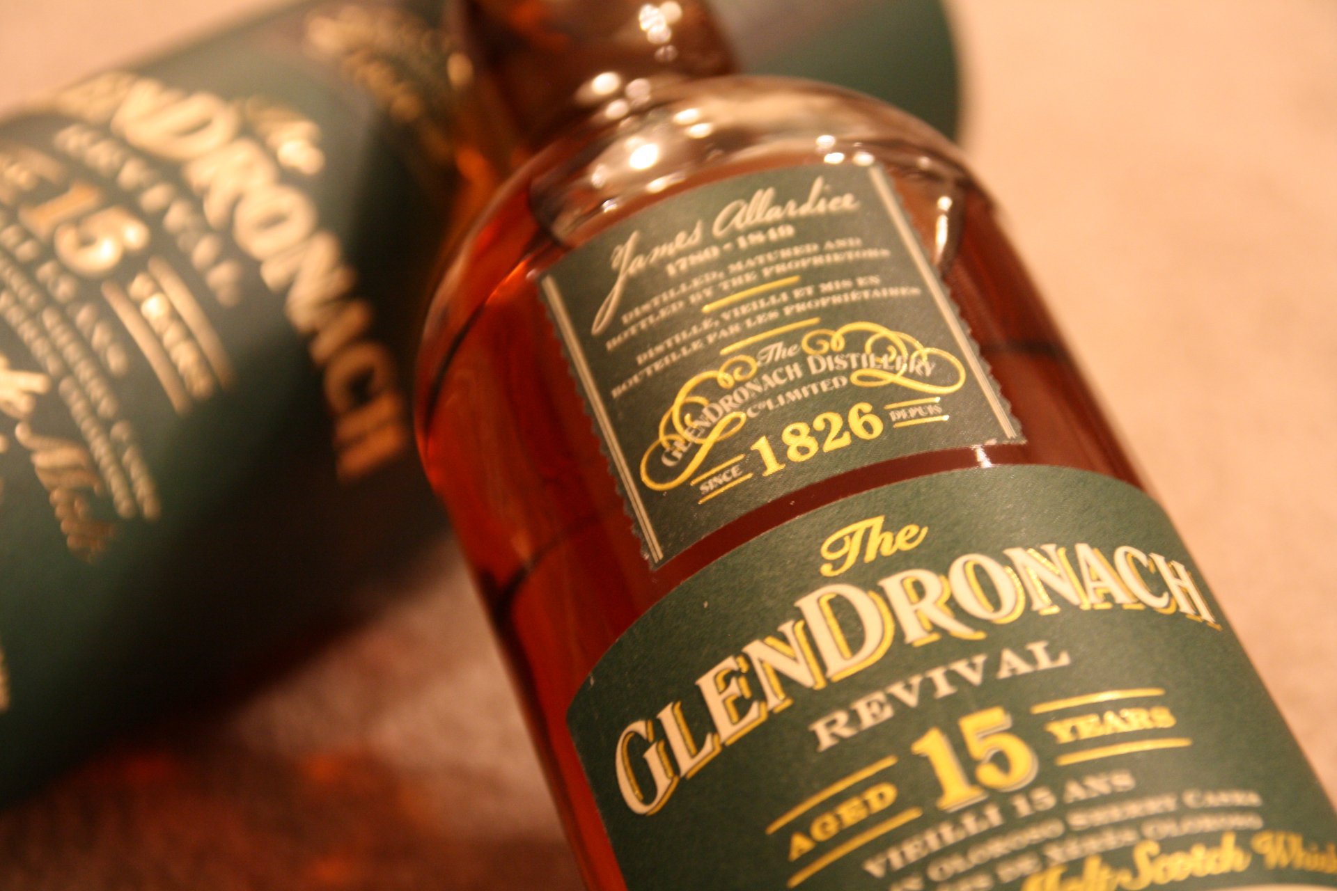 Close-up of GlenDronach 15-year-old whisky bottle with packaging, captured in 4K Ultra HD for a rich, detailed PC desktop wallpaper featuring food and whisky themes.