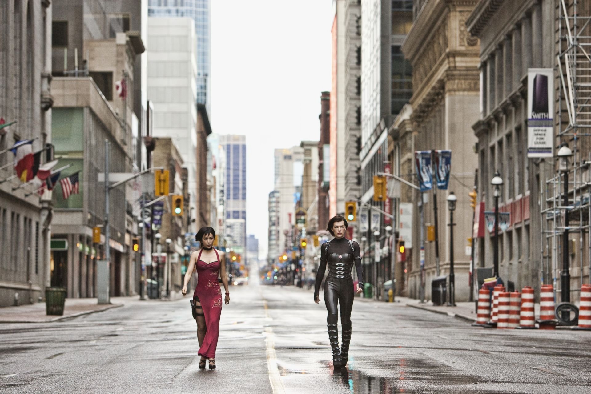 Two women walk down a deserted urban street, embodying the action and intensity of Resident Evil: Retribution, captured in this high-definition PC desktop wallpaper.