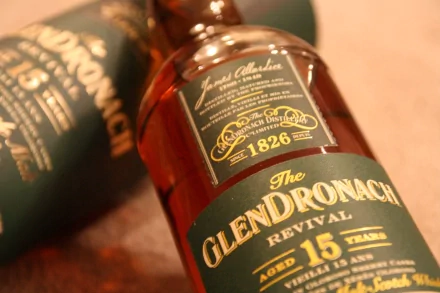 Close-up of GlenDronach 15-year-old whisky bottle with packaging, captured in 4K Ultra HD for a rich, detailed PC desktop wallpaper featuring food and whisky themes.