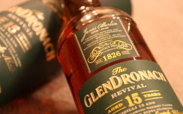 Close-up of GlenDronach 15-year-old whisky bottle with packaging, captured in 4K Ultra HD for a rich, detailed PC desktop wallpaper featuring food and whisky themes.