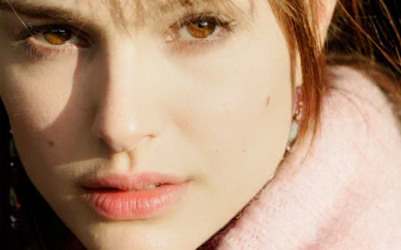 A close-up of Natalie Portman, showcasing her expressive features and warm, inviting gaze. This stunning image serves as a vibrant HD desktop wallpaper background.