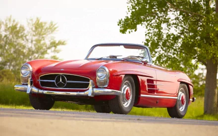 Classic red Mercedes-Benz 300SL roadster vehicle on a sunlit country road — HD PC desktop wallpaper and background.