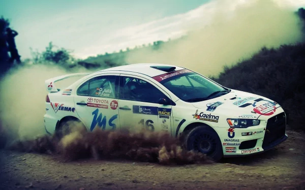 HD PC desktop wallpaper featuring a Mitsubishi rally vehicle kicking up dust on a dirt road, showcasing dynamic off-road action and vibrant motion.