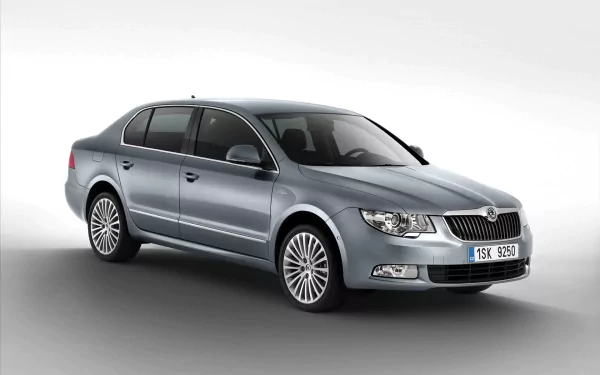HD PC desktop wallpaper of a silver Skoda vehicle sedan on a neutral gray background, three-quarter front view showcasing chrome grille and alloy wheels.