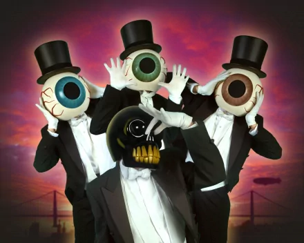 A striking HD wallpaper featuring The Residents, showcasing figures in tuxedos with oversized eyeball masks, creating a surreal and artistic representation of their unique musical style.
