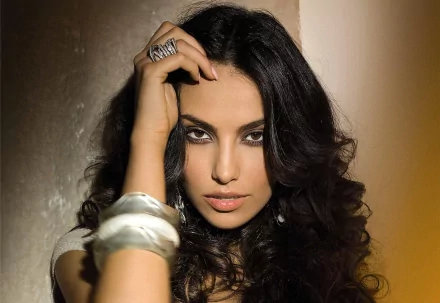 HD desktop wallpaper featuring a close-up portrait of a woman with dark curly hair and intense eyes, tagged as Mădălina Diana Ghenea.