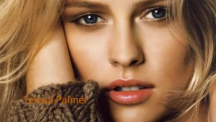 Close-up portrait of actress Teresa Palmer, showcasing her striking eyes and soft features. The image serves as a vibrant HD desktop wallpaper.