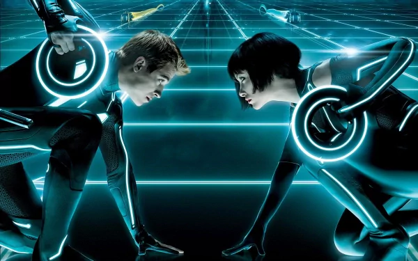 A high-definition wallpaper featuring Olivia Wilde as Quorra and Garrett Hedlund as Sam Flynn, set against the glowing digital landscape of TRON: Legacy.