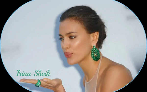 HD PC desktop wallpaper featuring celebrity model Irina Shayk wearing green earrings and a matching ring, posing against a light background.