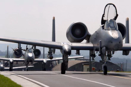 HD wallpaper featuring Fairchild Republic A-10 Thunderbolt II military aircraft taxiing on a runway, showcasing their iconic design and power in action.