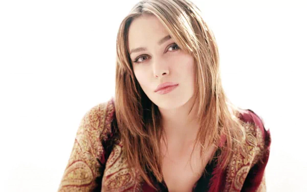 HD desktop wallpaper featuring celebrity Keira Knightley, with a soft, ethereal background highlighting her serene expression and intricate patterned clothing.