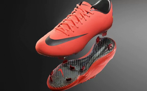 A vibrant red Nike shoe displayed with its sole visible, showcasing a sleek design. This HD image serves as an eye-catching wallpaper or background.