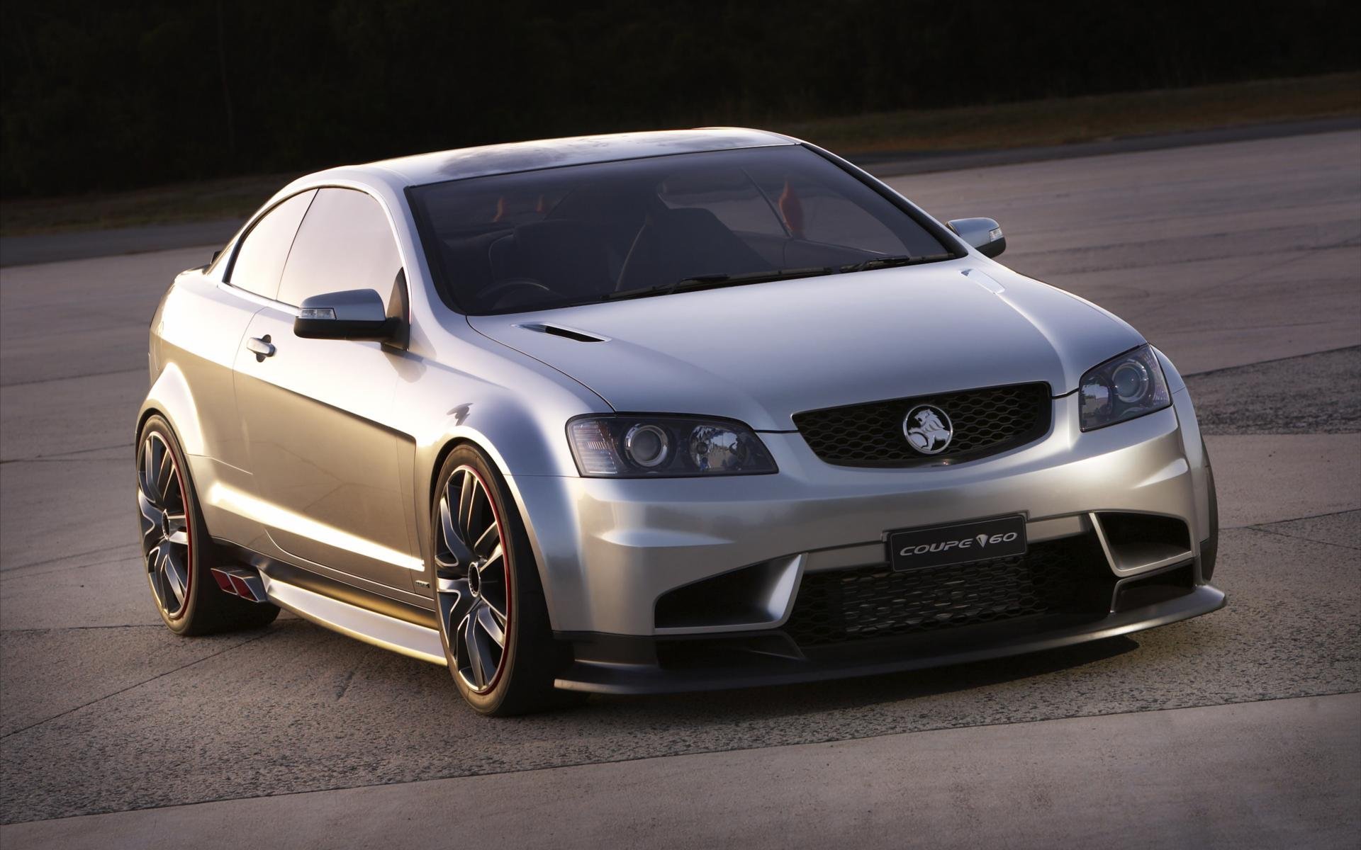 HD PC desktop wallpaper and background: sleek silver Opel coupe on open pavement, low stance, aggressive body kit and alloy wheels bathed in soft evening light.