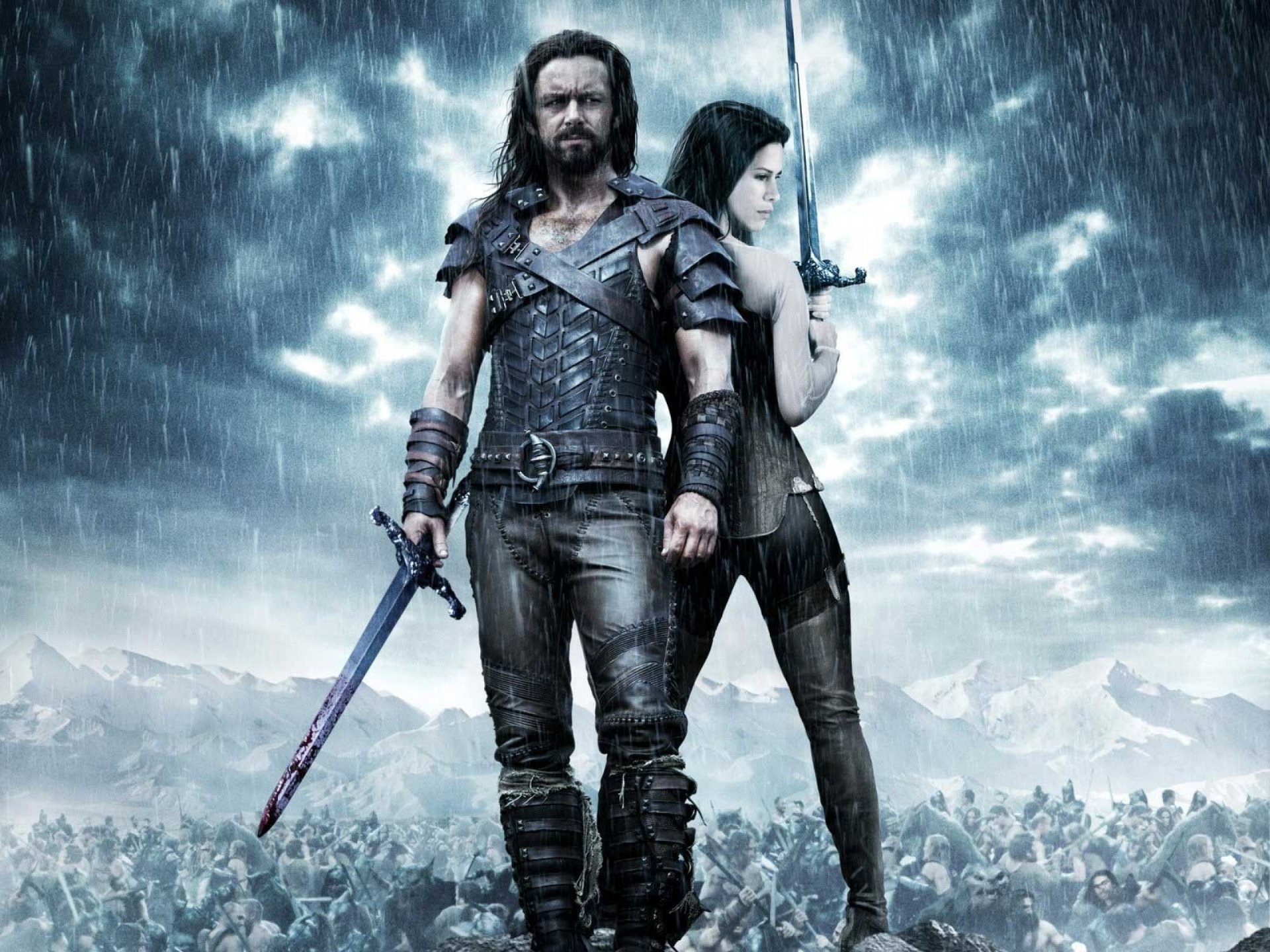 HD PC desktop wallpaper featuring characters from the movie Underworld: Rise of the Lycans, with a stormy, dark atmosphere and armored warriors.
