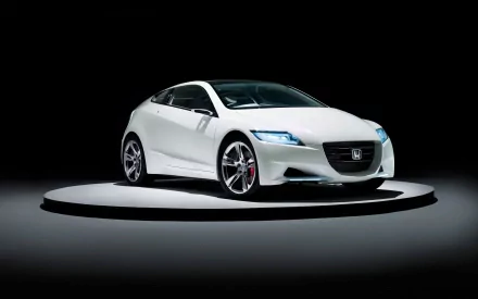 HD desktop wallpaper featuring a sleek white Honda CR-Z vehicle showcased on a circular platform against a dark background.