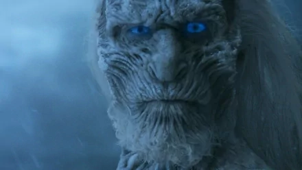 Close-up of a White Walker from the TV show Game of Thrones, featuring icy features and glowing blue eyes, set against a cold, atmospheric background. HD desktop wallpaper.