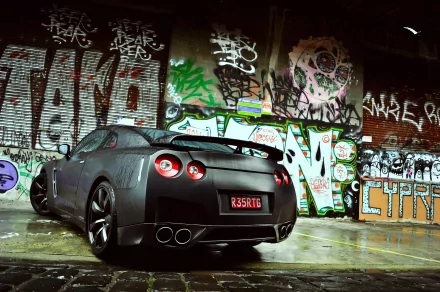 A Nissan sports car is parked in an urban setting, showcasing a sleek design against a vibrant graffiti backdrop. This high-definition image serves as an eye-catching desktop wallpaper.
