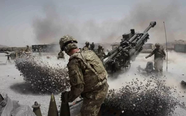 HD PC desktop wallpaper depicting military artillery crew operating a large cannon amid dust and smoke in a desert environment.