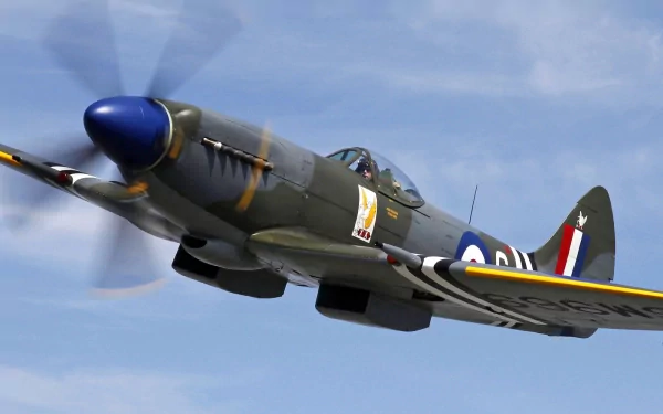 A historic military aircraft in flight, showcasing its detailed design and vibrant colors against a clear blue sky. This HD image serves as an impressive desktop wallpaper.