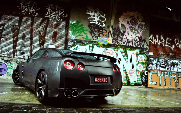 A Nissan sports car is parked in an urban setting, showcasing a sleek design against a vibrant graffiti backdrop. This high-definition image serves as an eye-catching desktop wallpaper.