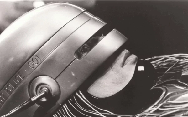 Monochrome HD PC desktop wallpaper of RoboCop (1987) — close-up of his helmet and faceplate from the movie, cinematic sci‑fi background.