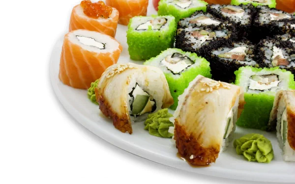 A vibrant array of sushi rolls, including salmon, cucumber, and spicy varieties, arranged elegantly on a plate, set against a clean backdrop. 4K Ultra HD desktop wallpaper.