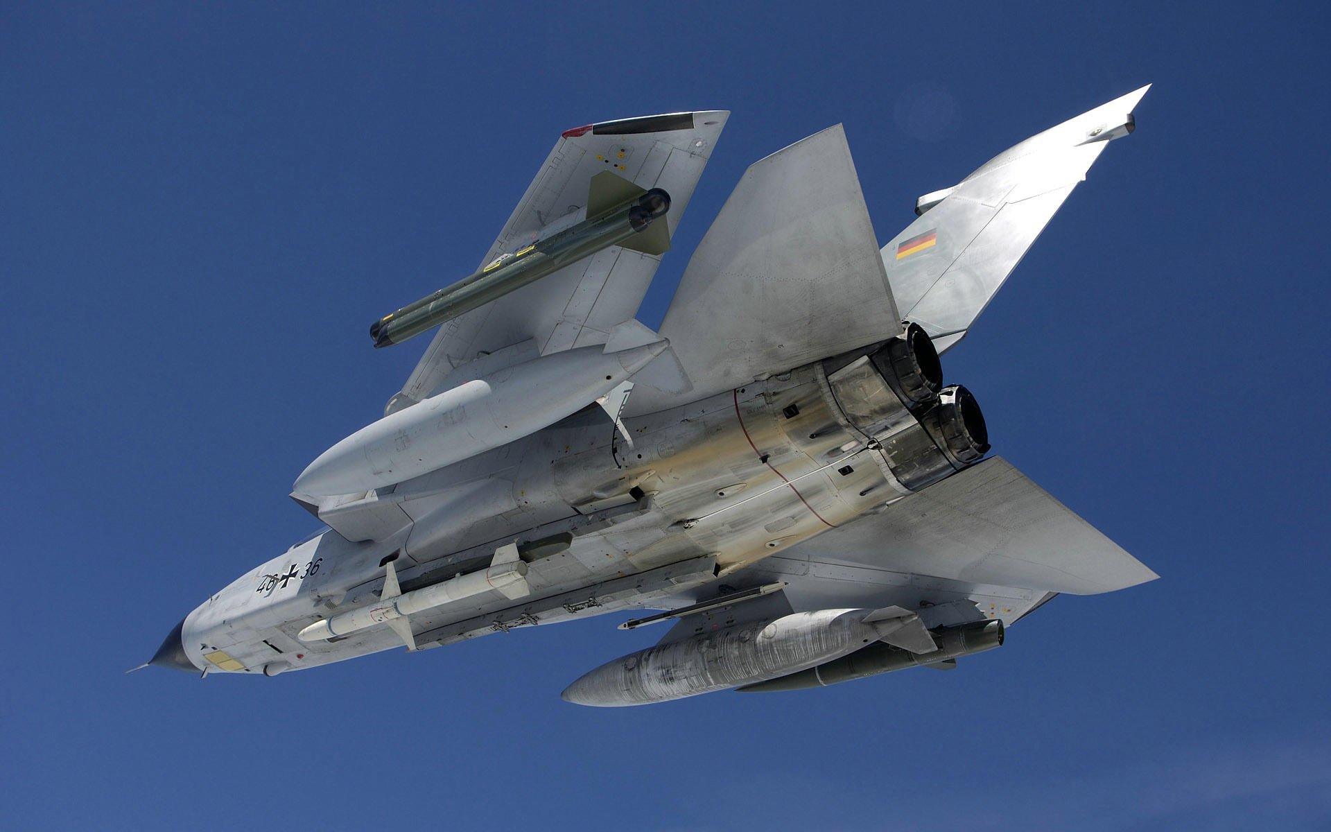 HD PC desktop wallpaper and background: military Panavia Tornado in flight photographed from below against a clear blue sky.