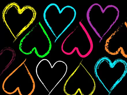 A vibrant HD desktop wallpaper featuring colorful, artistic heart shapes on a black background, evoking the theme of love.