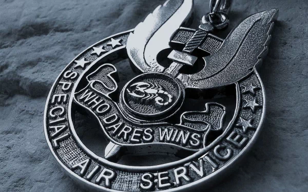 HD desktop wallpaper featuring a close-up of a Special Air Service military medal with the motto Who Dares Wins on a textured background.