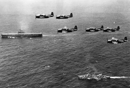 HD PC desktop wallpaper: military air squadron of Grumman TBF Avenger torpedo bombers flying in formation over aircraft carriers and escort ships at sea.