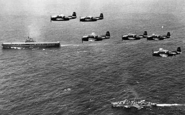 HD PC desktop wallpaper: military air squadron of Grumman TBF Avenger torpedo bombers flying in formation over aircraft carriers and escort ships at sea.