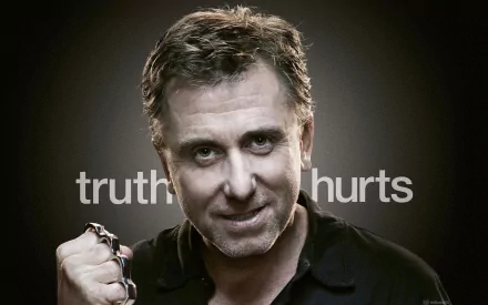 HD desktop wallpaper from the TV show Lie to Me, featuring a confident man with the phrase truth hurts in the background.